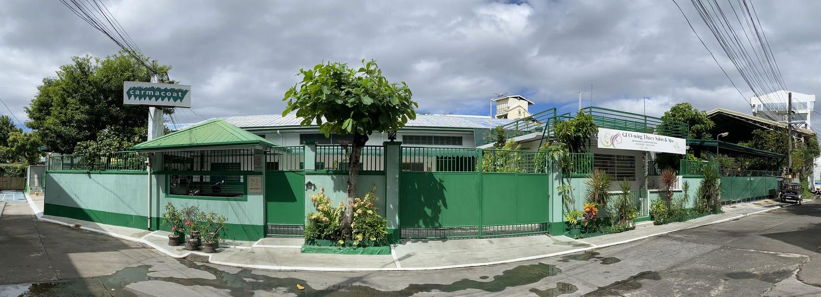 The image depicts a panoramic view of the Carmacoat building 