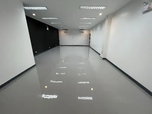 This image shows an empty office with Carmacoat's newly installed grey epoxy flooring
