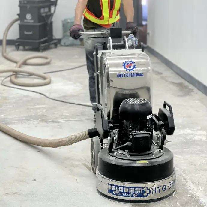 The image depicts a Carmacoat employee with a mechanical grinder in use